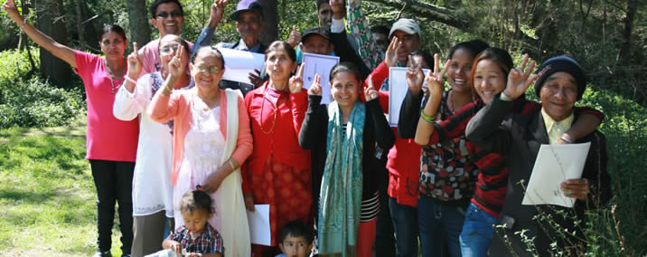 Women from multicultural backgrounds smile for a group photo